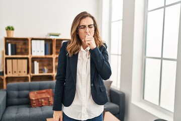 Young woman working at consultation office feeling unwell and coughing as symptom for cold or bronchitis. health care concept.