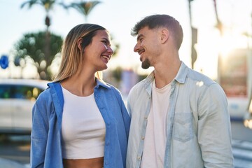 Obraz premium Young man and woman couple smiling confident standing together at street