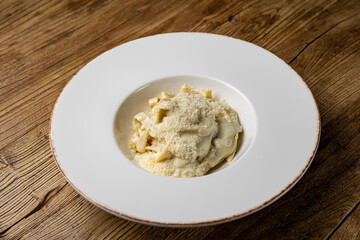 delicious pasta with 4 types of cheese and sauce on a plate from a restaurant
