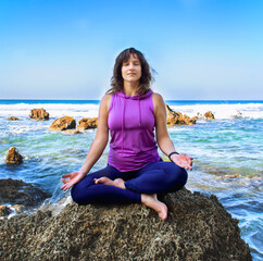 Woman doing yoga on a beach