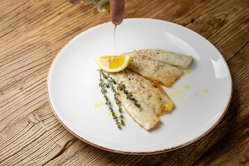 a delicious dish of sea bream on a plate prepared in a restaurant.
