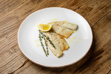 a delicious dish of sea bream on a plate prepared in a restaurant.
