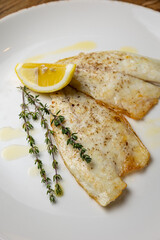 a delicious dish of sea bream on a plate prepared in a restaurant.
