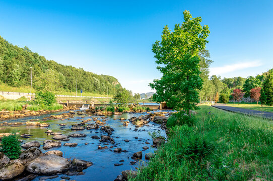 A walk path along scenic small river with rocks close to Algard town, Norway, June 2018