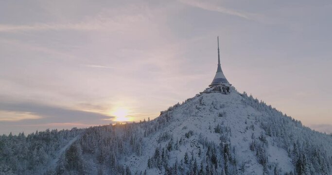 Jested tower mountain hill with snow mist and fog at golden hour