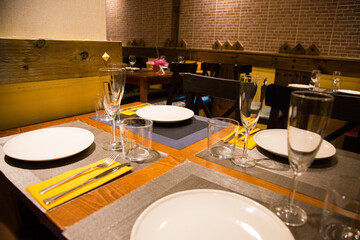 Elegant restaurant table with cutlery, crockery and glasses.