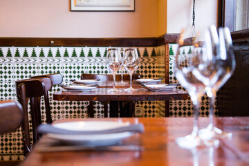 Elegant restaurant table with cutlery, crockery and glasses.