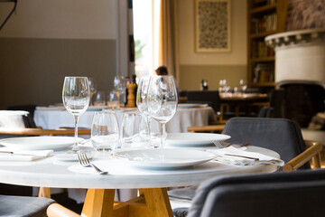 Elegant restaurant table with cutlery, crockery and glasses.