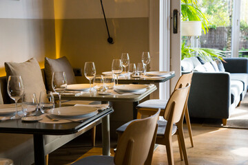 Elegant restaurant table with cutlery, crockery and glasses.