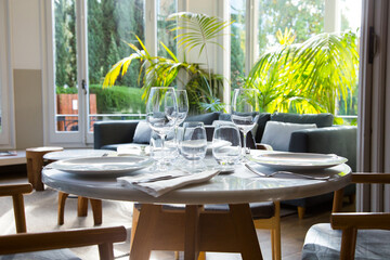 Elegant restaurant table with cutlery, crockery and glasses.