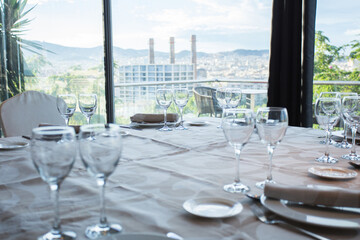 Elegant restaurant table with cutlery, crockery and glasses.