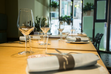 Elegant restaurant table with cutlery, crockery and glasses.