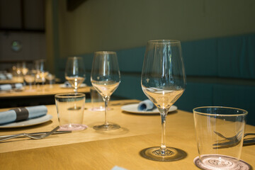 Elegant restaurant table with cutlery, crockery and glasses.