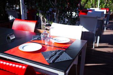Elegant restaurant table with cutlery, crockery and glasses.