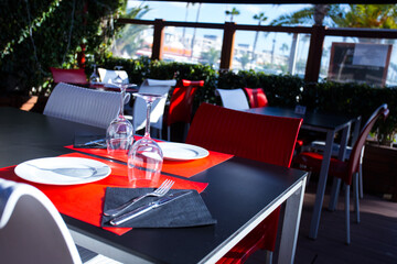 Elegant restaurant table with cutlery, crockery and glasses.