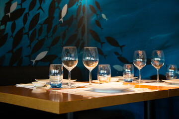 Elegant restaurant table with cutlery, crockery and glasses.