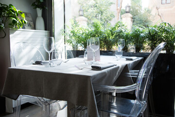 Elegant restaurant table with cutlery, crockery and glasses.
