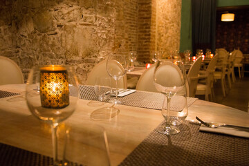 Elegant restaurant table with cutlery, crockery and glasses.