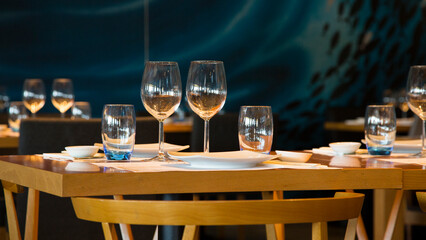 Elegant restaurant table with cutlery, crockery and glasses.