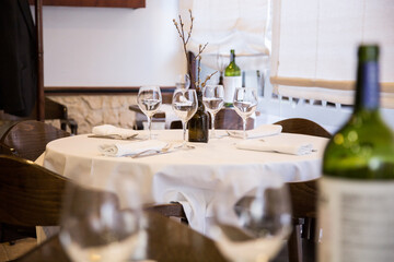 Elegant restaurant table with cutlery, crockery and glasses.