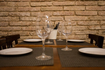 Elegant restaurant table with cutlery, crockery and glasses.