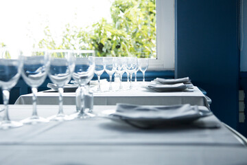 Elegant restaurant table with cutlery, crockery and glasses.