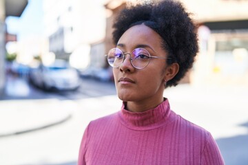 Fototapeta premium African american woman looking to the side with serious expression at street