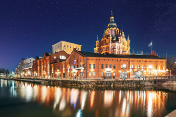 Helsinki, Finland. View Of Kanavaranta Street With Uspenski Cathedral In Evening Night Illuminations. Colourful Night Starry Sky In Dark Blue Colors. Sky Glowing Stars Background With Sky Gradient.