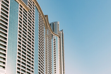 Wall With A Balcony Of New Empty Modern Multi-storey Residential Building House In Residential Area On Sunny Blue Sky.