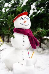 Poetry snowman. A snow man build in the court yard dressed in literature style with glasses, scarf and bonnet.