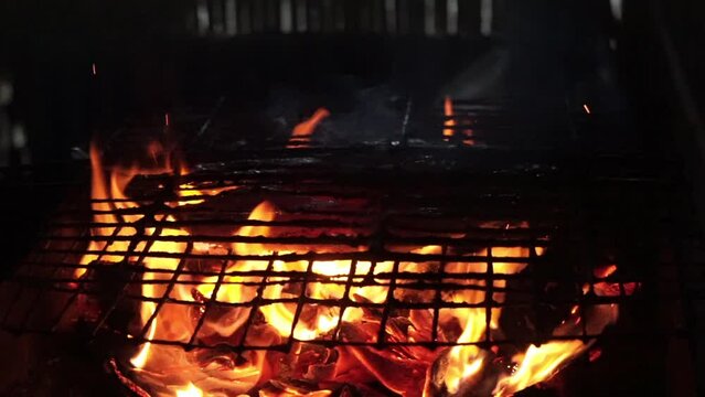 cooking grilled fish on the grill, filled with wood charcoal and smoldering fire.grilled fish food east java, indonesia.