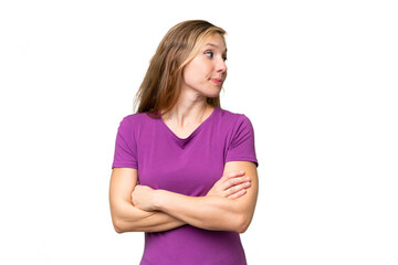 Young blonde woman over isolated background keeping the arms crossed