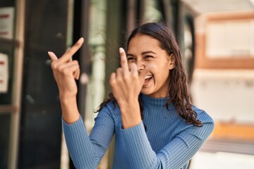 Young african american woman smiling confident doing bad gesture with finger at street