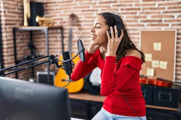 Fototapeta premium Young african american woman artist singing song at music studio