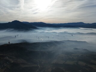 Aerial View. Flying over the high mountains in beautiful clouds. Aerial Drone camera shot. Air...
