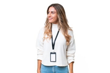 Young Uruguayan woman with ID card over isolated background looking to the side and smiling