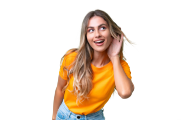 Young Uruguayan woman over isolated background listening to something by putting hand on the ear