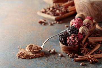 Chocolate truffles and spoon with cocoa powder.