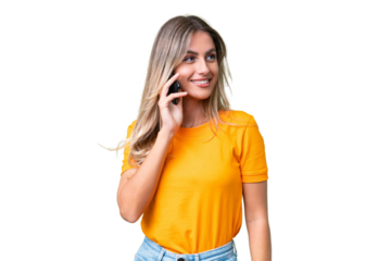 Young Uruguayan woman over isolated background keeping a conversation with the mobile phone with someone