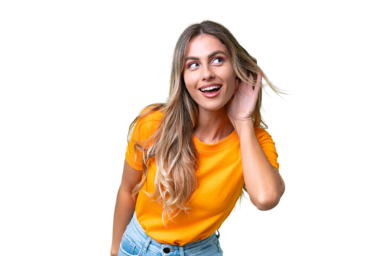 Young Uruguayan woman over isolated background listening to something by putting hand on the ear