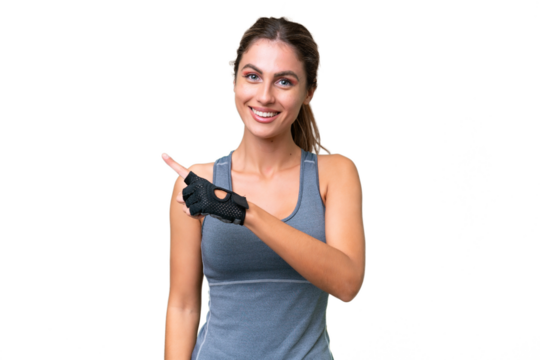 pretty Sport Uruguayan woman over isolated background pointing to the side to present a product