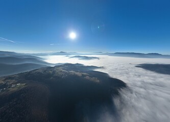 Aerial View. Flying over the high mountains in beautiful clouds. Aerial Drone camera shot. Air...