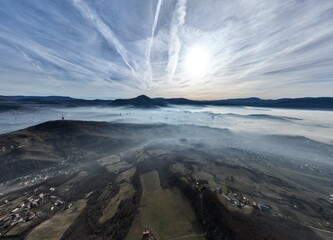 Aerial View. Flying over the high mountains in beautiful clouds. Aerial Drone camera shot. Air...