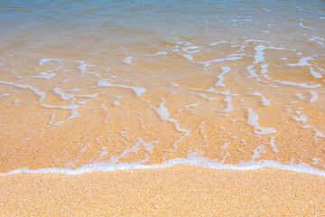 The coast of the Sea of Azov. Sea waves roll on the sandy shore. Seashell sandy beach.