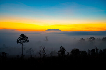Aerial view background of sunlight , sunrise over mountain with fog over the ground in foreground savannah Meadow , Petchaboon province, Thailand,asia.Soft focus.