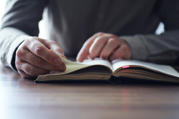 Read book. A man sits and reads literature. Textbooks to study. Religion.