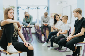 Fototapeta premium Children sit on tables during extracurricular activities at school