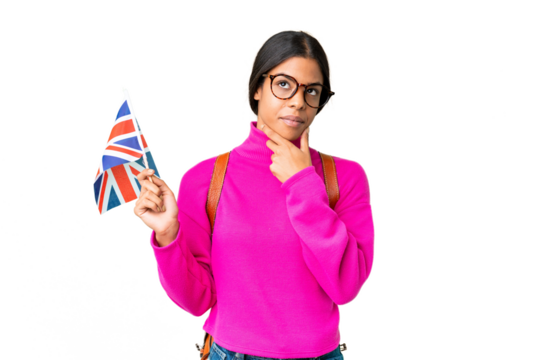 Young African American woman holding an United Kingdom flag over isolated chroma key background having doubts
