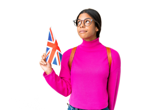Young African American woman holding an United Kingdom flag over isolated chroma key background and looking up