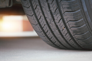 Closeup of the tread of a summer car tire on a sunny day. tires against black. fuel efficient car...